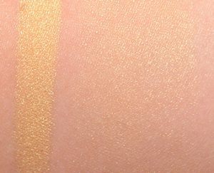 Becca Skin Perfector in Champagne Pop highlighter swatch on skin