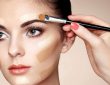 concealer application on a face with brush