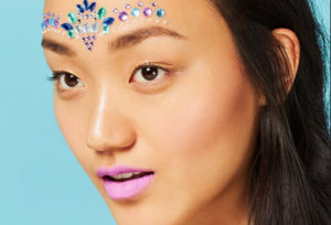 girl wearing makeup with glitter and gems