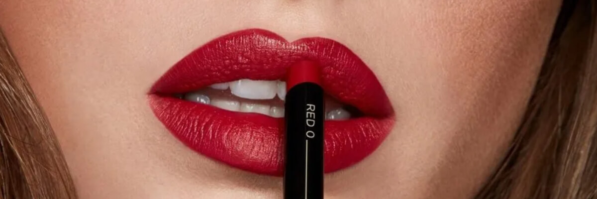01. ruby red lipstick being applied on lips