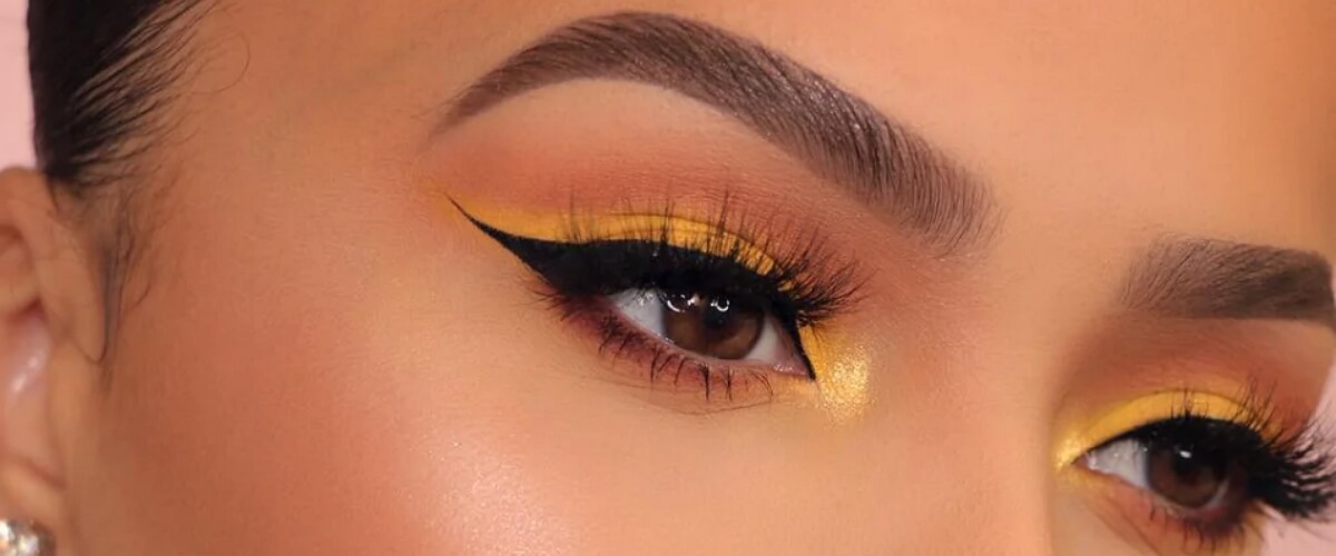 Eye makeup with neon yellow eye shadow in the inner corner of eye