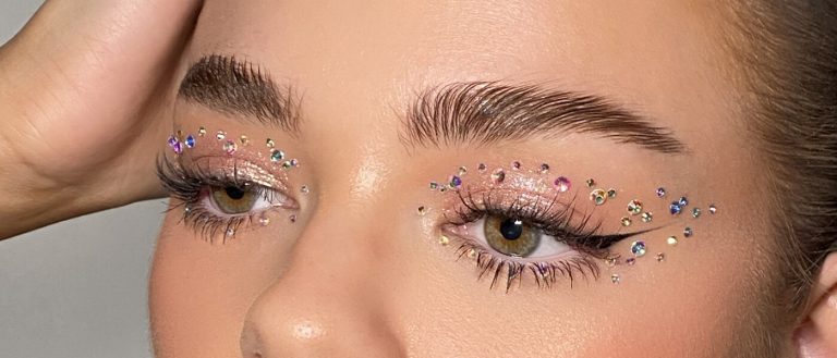 Woman with glitter eyeshadow and rhinestones makeup