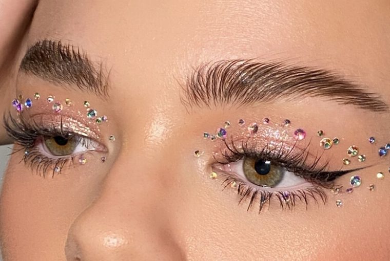 Woman with glitter eyeshadow and rhinestones makeup