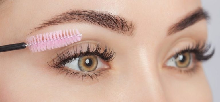 A lady applying fake lashes
