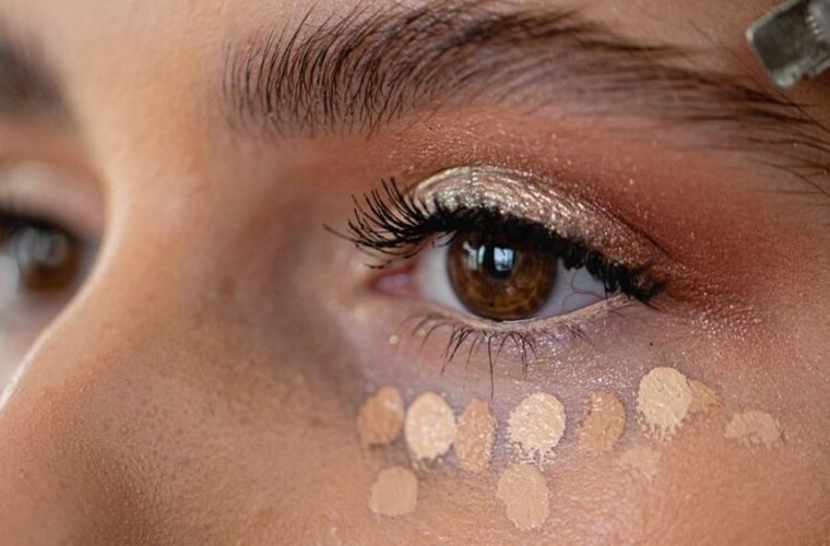 Lady with the water-based concealer applied under the eyes