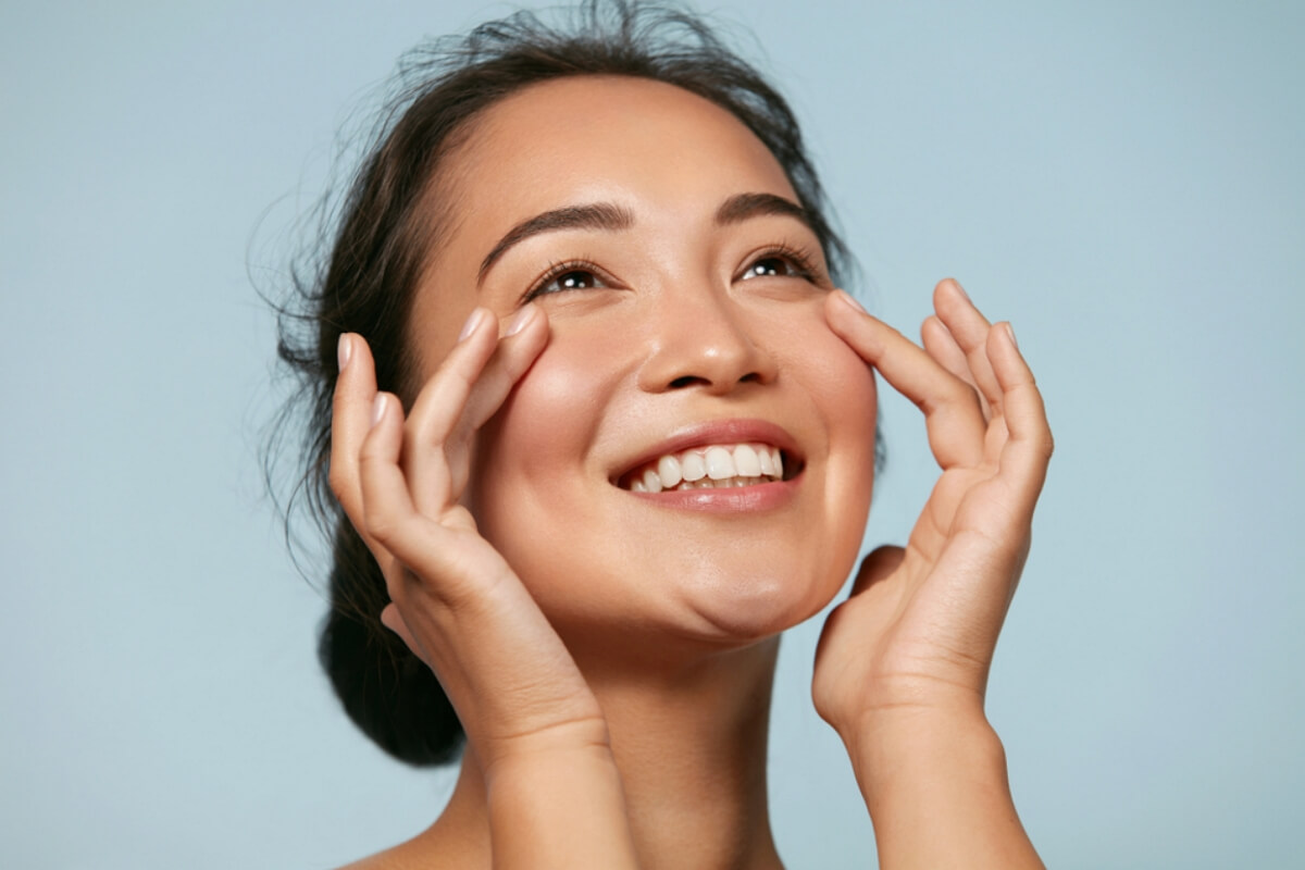 Smiling asian lady with perfect skin texture and light skin face