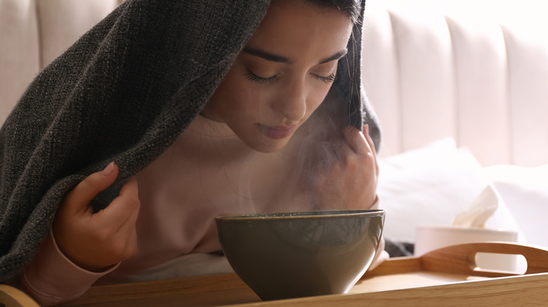 Woman steaming her face.