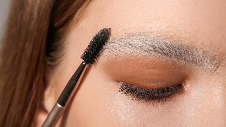combing spoolie through bleached brows