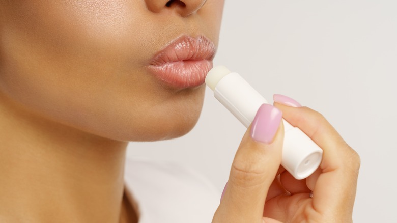 woman applying lip balm